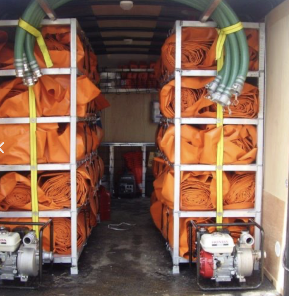Tiger Dam storage trailer with stacked tubes and Honda fill pumps — rapid-response logistics